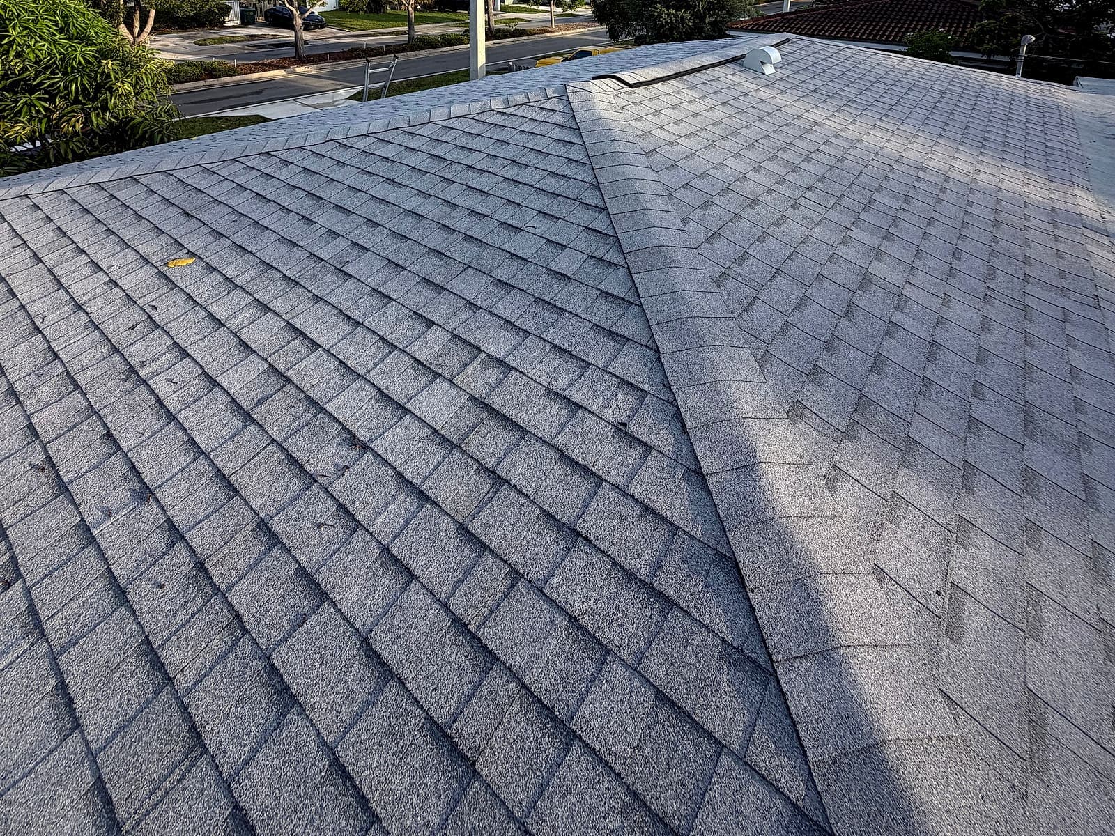 Completed architectural shingle roof with a view of the surrounding street