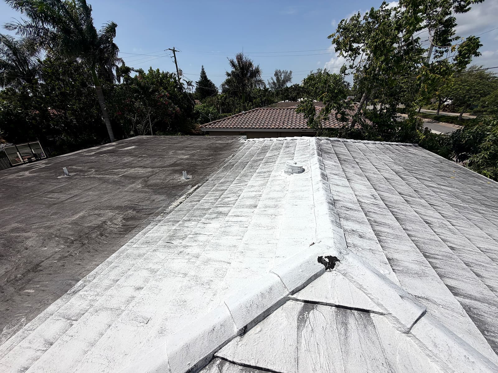 Existing flat and sloped roof sections before the shingle and modified bitumen roof replacement